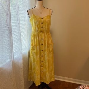 Yellow leaf print, adjustable spaghetti strap dress with pockets.